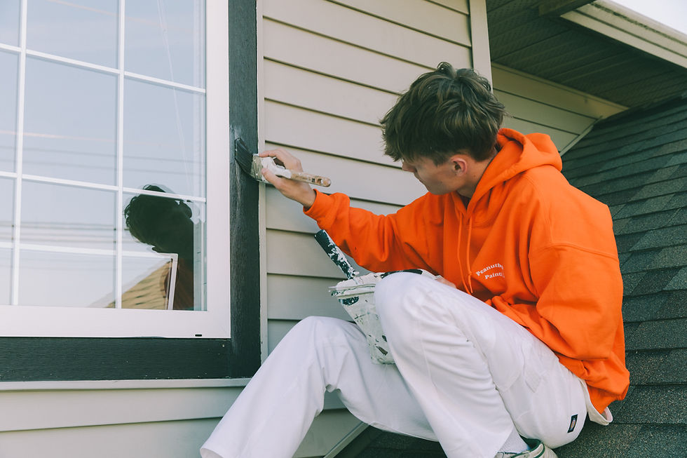 Painter from Peanut Butter Painting working on a residential home exterior in Chilliwack BC.