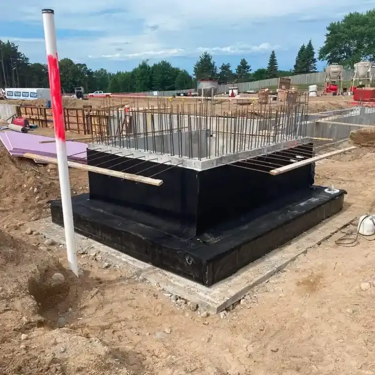 elevator pit with waterproofing being applied on a construction site