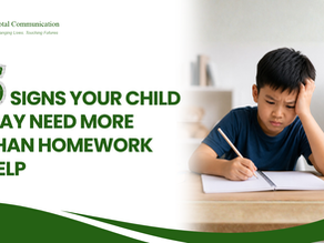 A young boy struggling with homework at a desk, looking frustrated while writing in a notebook, with books and stationery around him. Total Communication supports children in developing the skills they need to learn with greater confidence.
