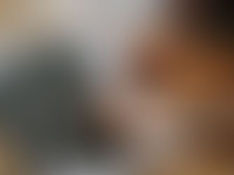 Close-up of a person typing on a MacBook laptop at a workspace