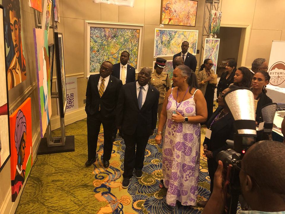 Nicole Collie is with The Prime Minister of The Bahamas and showing him art