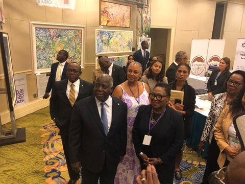 Nicole Collie is with The Prime Minister of The Bahamas and showing him art