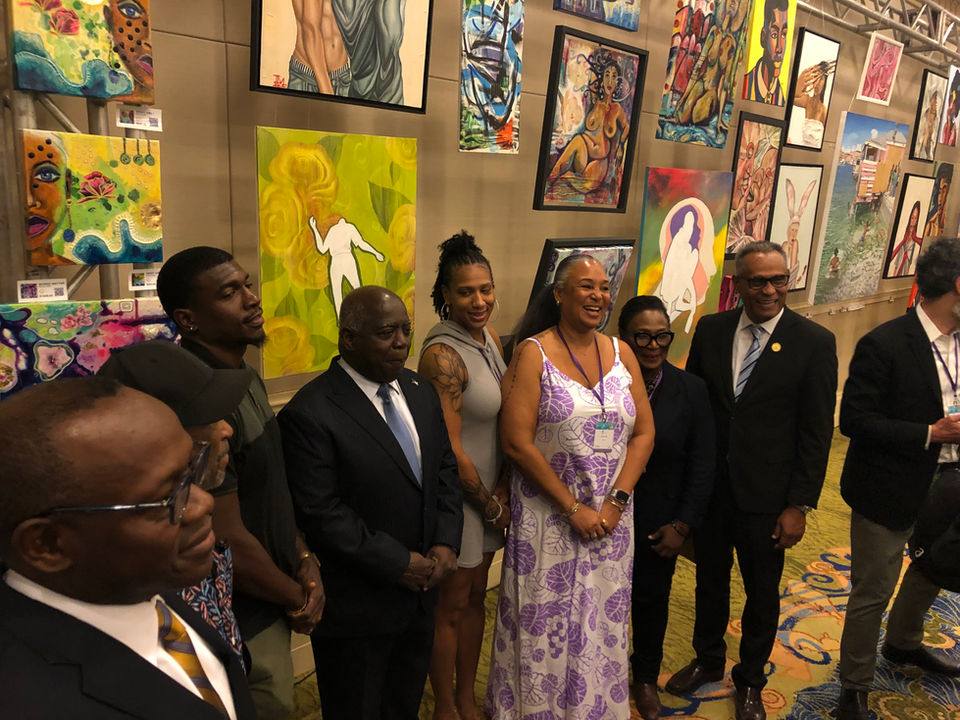 Nicole Collie is with The Prime Minister of The Bahamas and showing him art