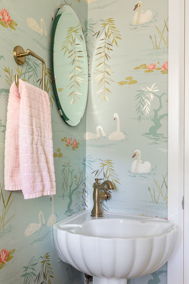 Powder room made special with unique wallpaper and sink.