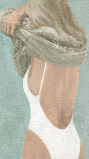 woman in bathing suit taking her sweater off