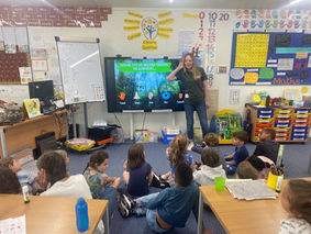 School children copying teacher listening