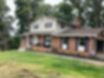 A beautiful house is showcased with newly installed gutters, seamlessly integrated along the rooflin