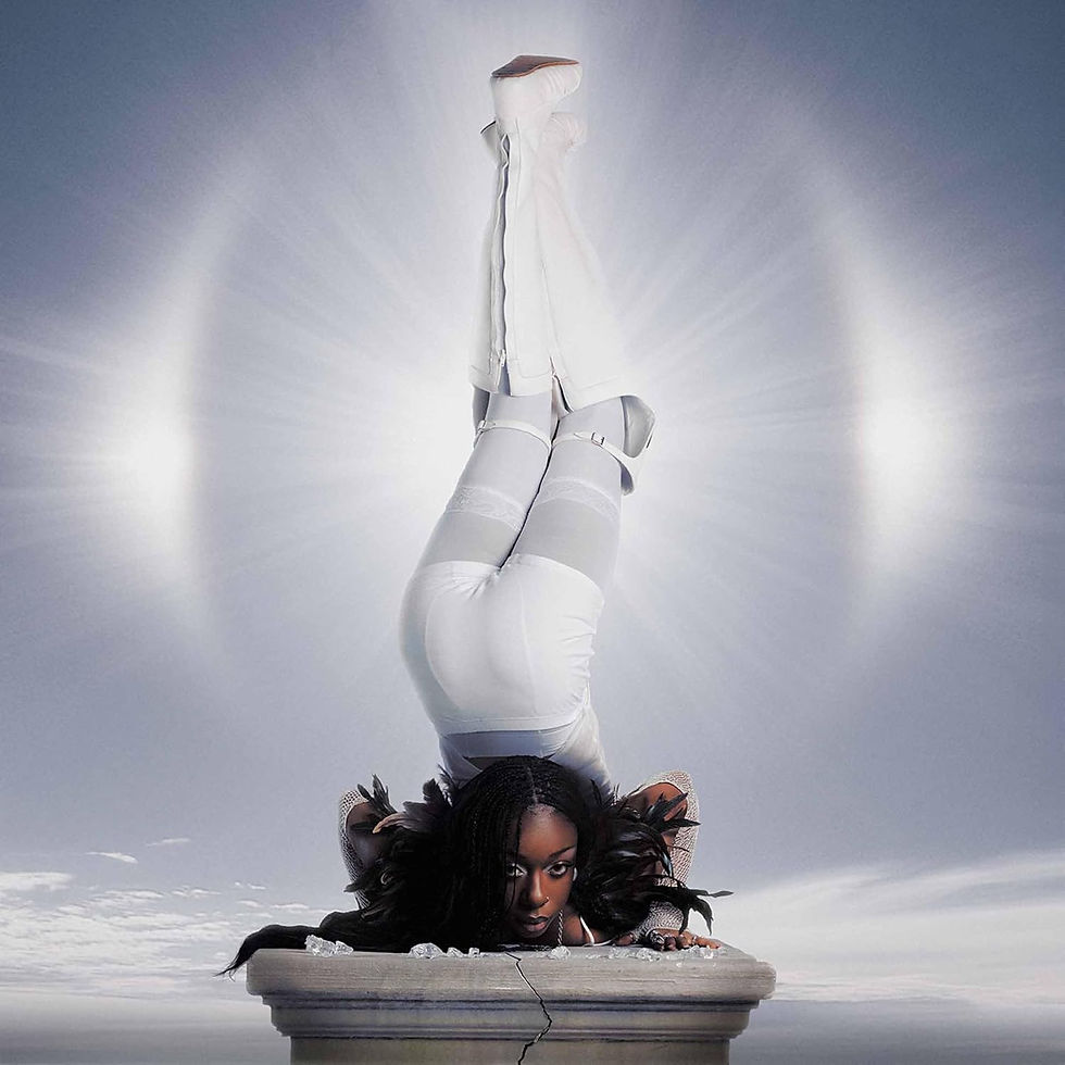 Thumbnail: Woman upside down on pedestal with bright halo background scene. The One Collection