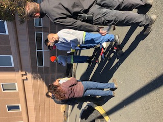 Renée and Erika gather with students for a bulb planting lesson outside the county jail; Boston, MA