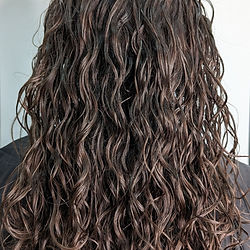 Long, loose, wavy, brown, hydrated hair.