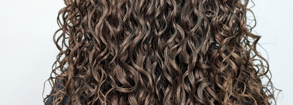 Long, auburn, loose curly hydrated hair