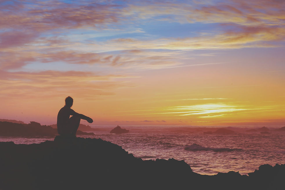 silhouette of a man by the shore