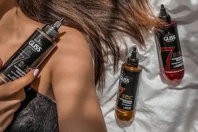 High angle view of hair care products arranged on a wooden shelf