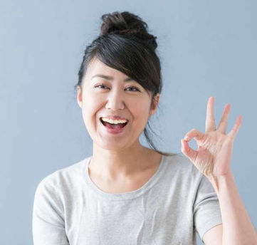 Happy woman gives OK sign