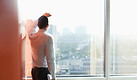 Man Looking Through a Window
