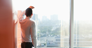 Man Looking Through a Window