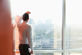 Man Looking Through a Window