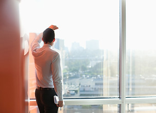 Man Looking Through a Window