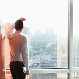 Man Looking Through a Window