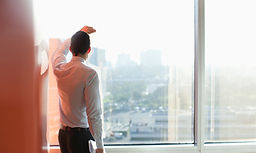 Man Looking Through a Window