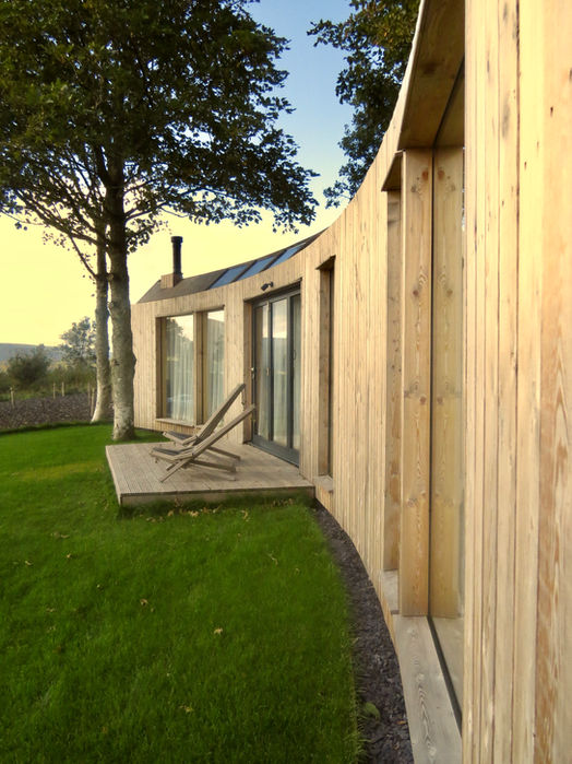 Caerlaverock Curve with elegant curved exterior , decking and deck chairs