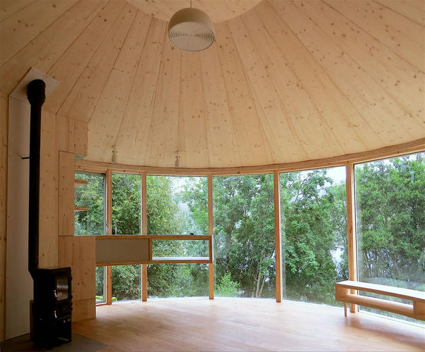 Am Falachan Roundhouse  with spruce panelled ceiling , hand built bench and kitchen. Cabin  and fixtures designed and built by Echo Scotland 