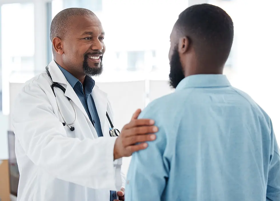 male doctor with his hand on the shoulder of his patient, smiling with reassurance