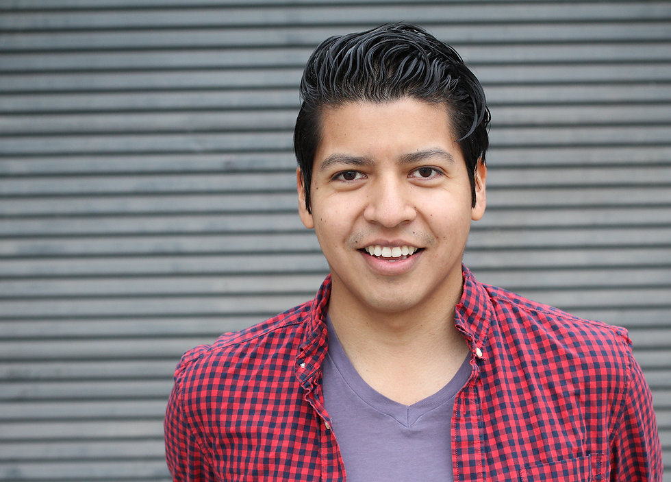 Hispanic man smiling.