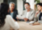 woman interviewing for a job with a group of three: two women and a man, with concerned looks on their faces.