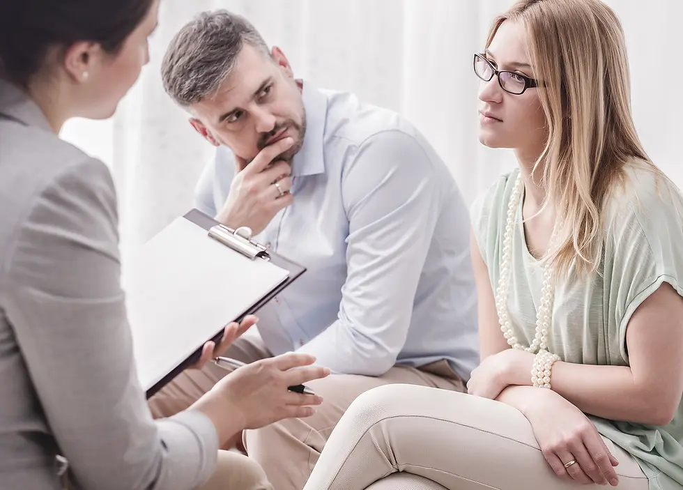 a male and female couple sitting with a woman discussing their divorce case, both the couple has distressed looks on their faces