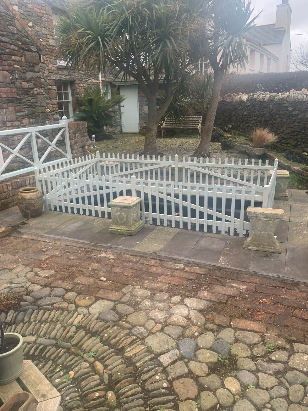 Decorative white garden fence installed around patio – JDM Building Services Isle of Man