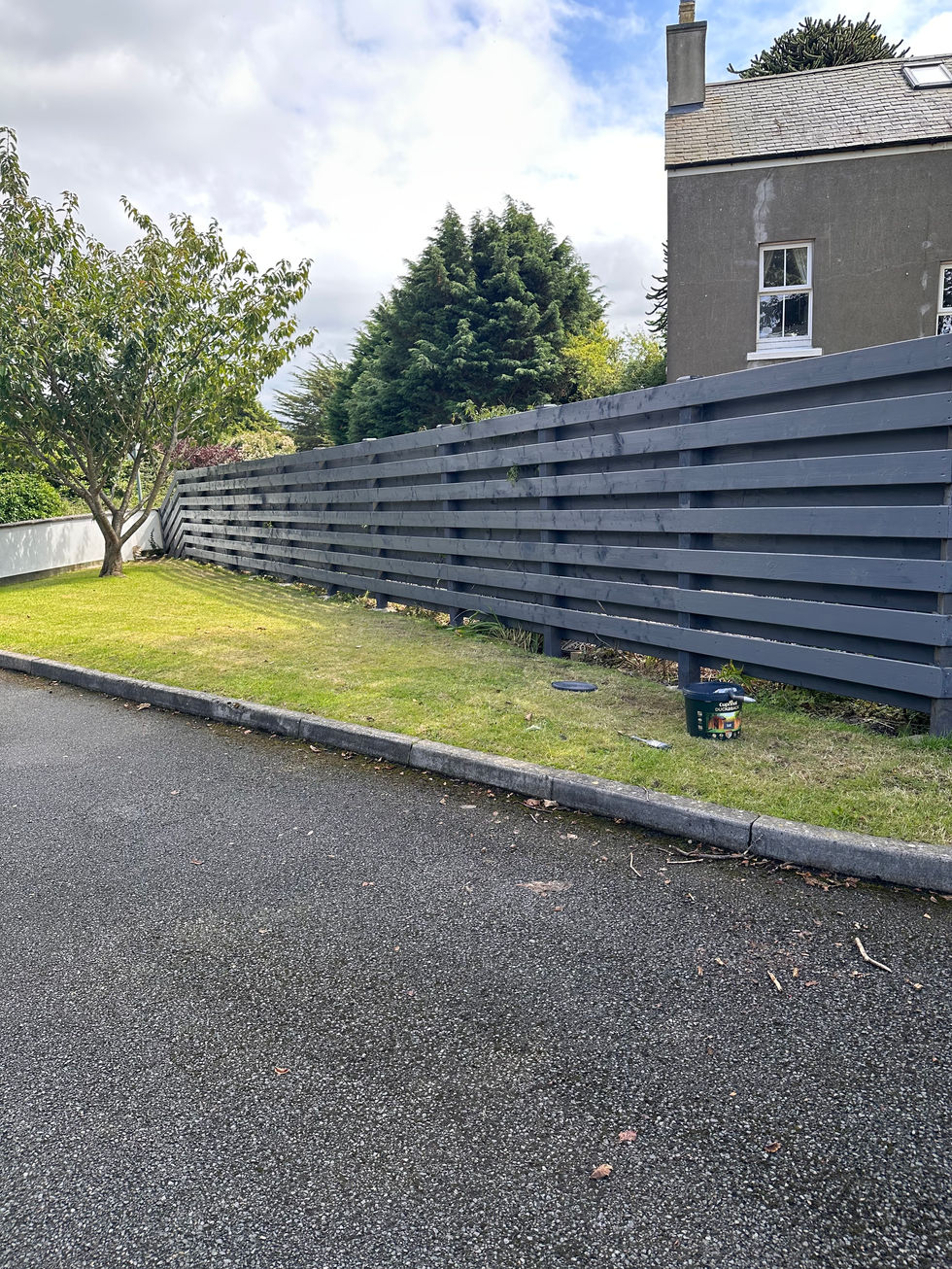 Completed grey horizontal slat fence installed along driveway – JDM Building Services Isle of Man