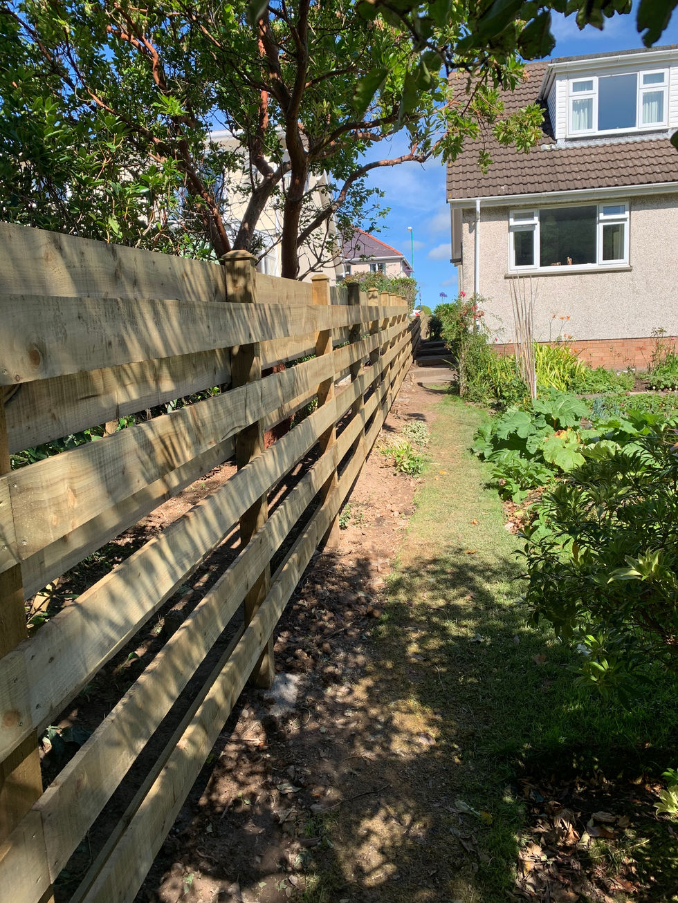 Horizontal boundary fence installed beside garden walkway – JDM Building Services Isle of Man