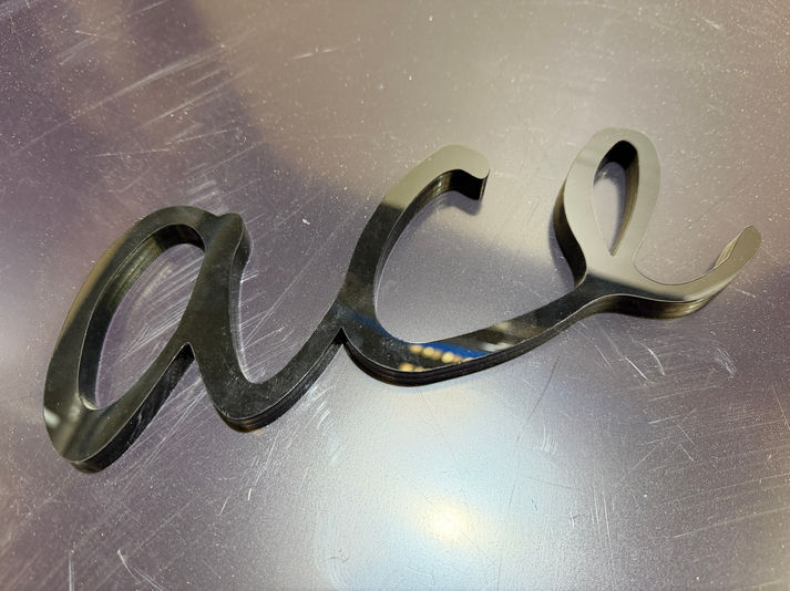 Laser-cut lettering in 10 mm black acrylic by Webb Plastics