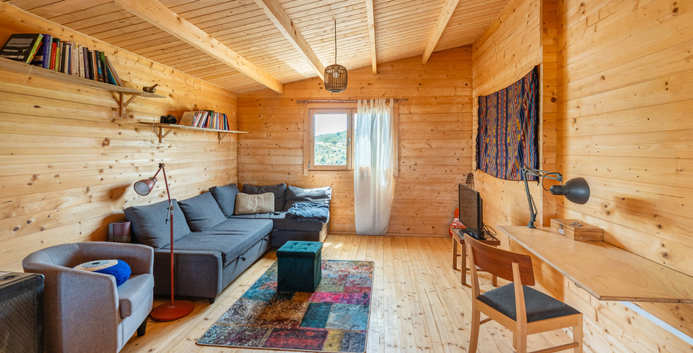 The wooden living area adds warmth and helps buyers understand the usable interior space of the prop