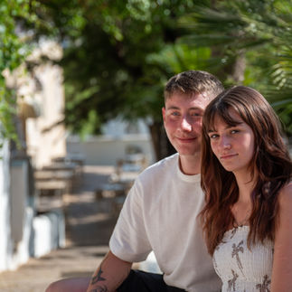 Couple sitting together in shaded garden area of Silves during portrait photography session