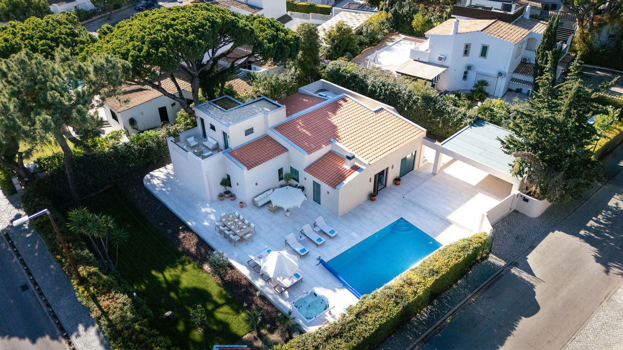 High angle view of a luxury villa pool area with sunset lighting