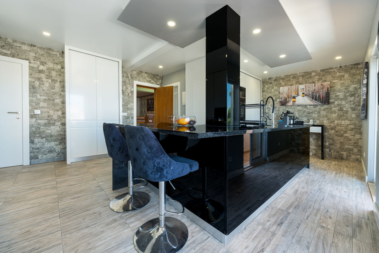 Modern kitchen with breakfast bar inside a Divine Home villa.