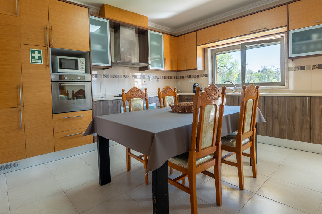 Open plan kitchen and dining area with wooden cabinets Algarve