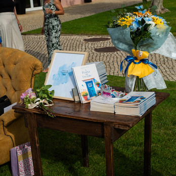 Display table with books and flowers.