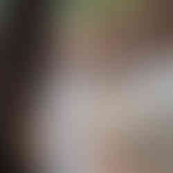 Young woman leaning against a tree near Silves Cathedral during a portrait photoshoot