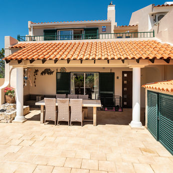 Covered terrace and outdoor patio area at a Divine Home villa.
