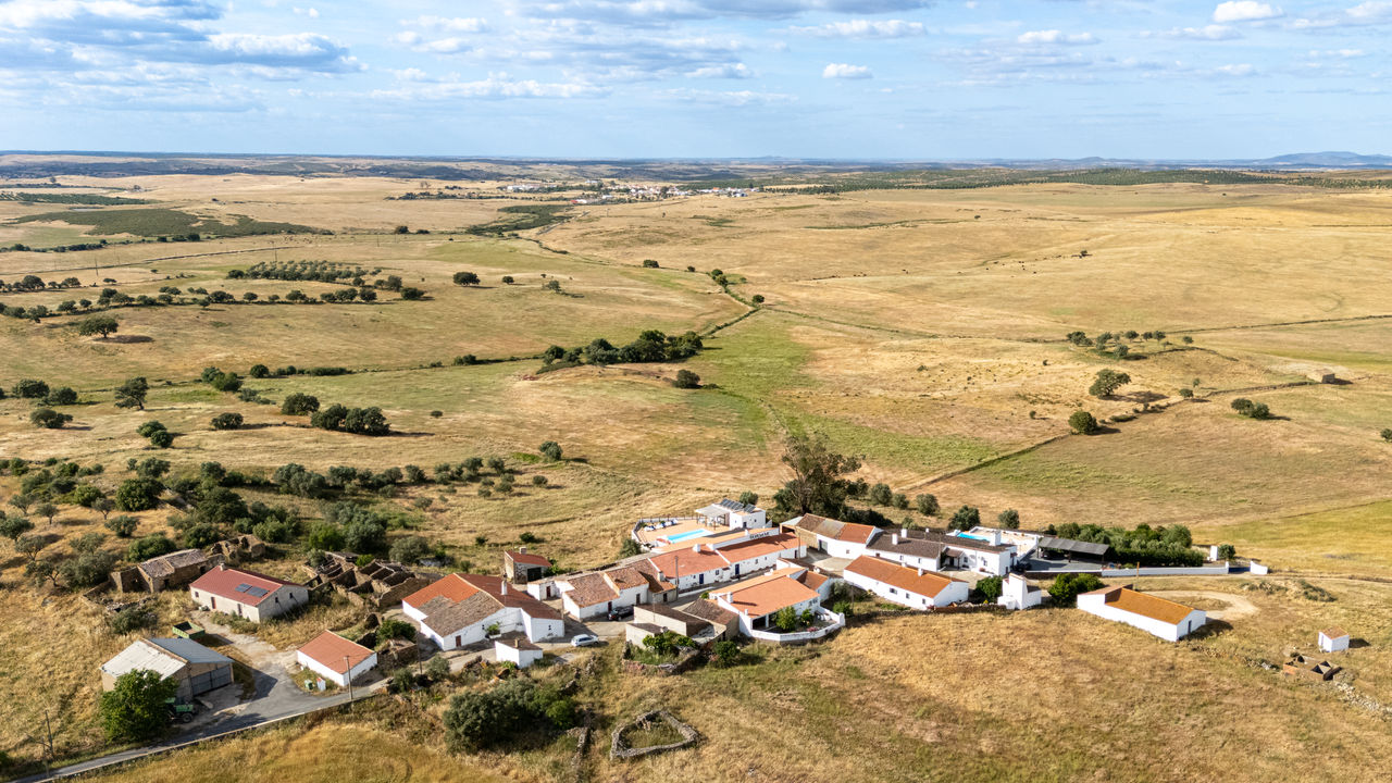 Aerial drone view of Monte Do Castelejo surrounded by open Alentejo countryside in Southern Portugal.