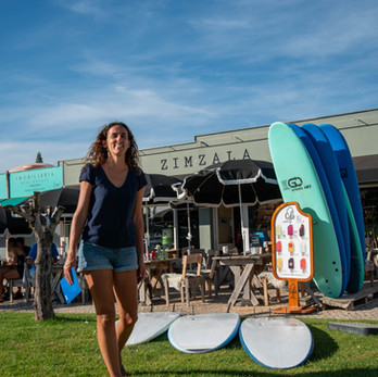 Author walking past surfboards at the venue.