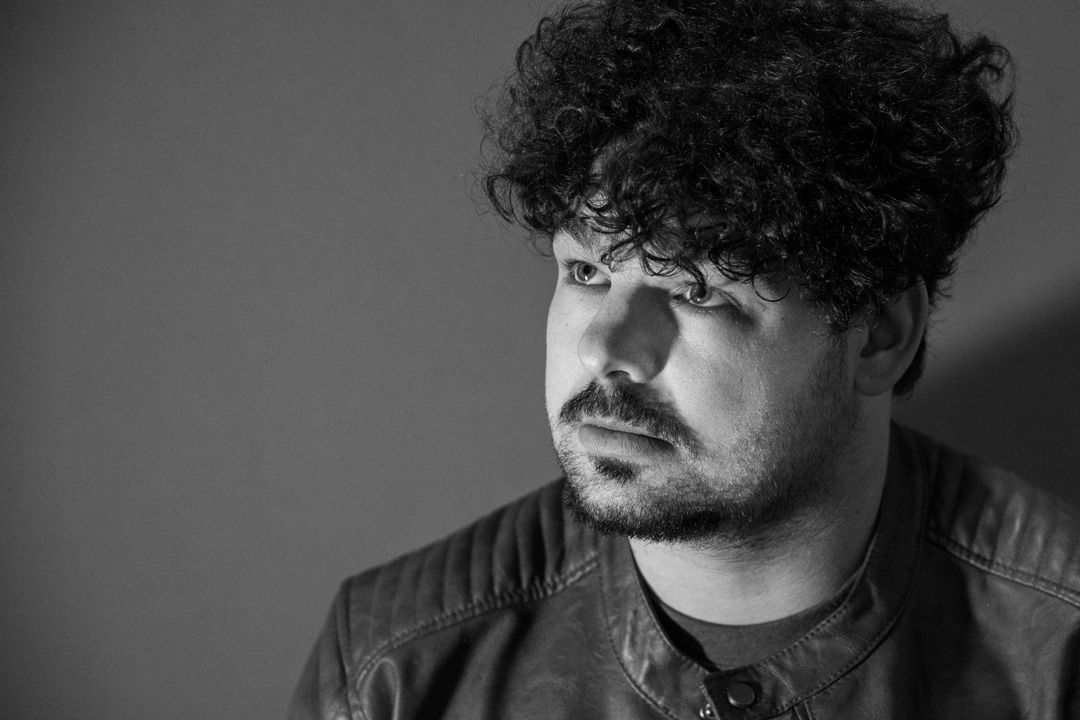 Black and white profile portrait of the musician.