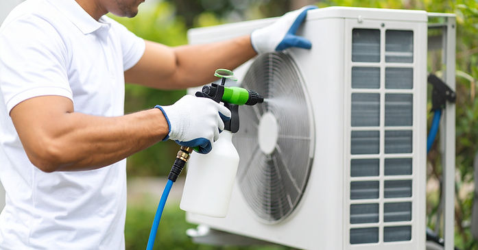 HVAC technician servicing a heating and cooling system in a Portland, OR home.