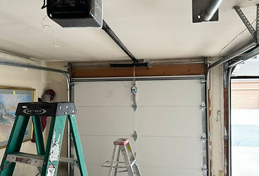 BlackBear technician performing a detailed garage door safety inspection on a Denver home