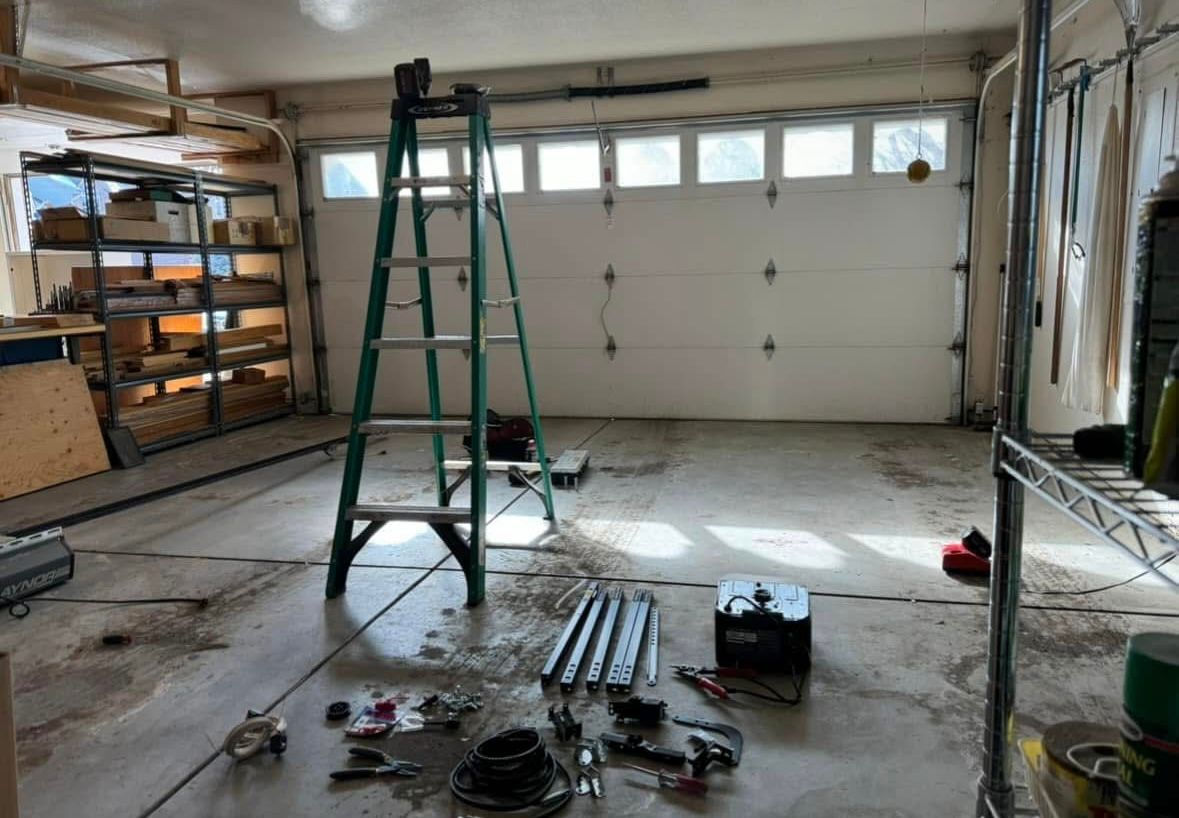 Technician inspecting garage door sensors and opener safety features in a Long Beach home