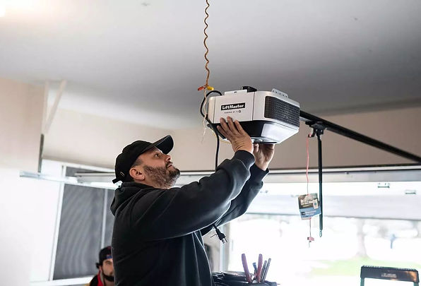 BlackBear technician installing a Craftsman garage door opener in a Denver residential garage