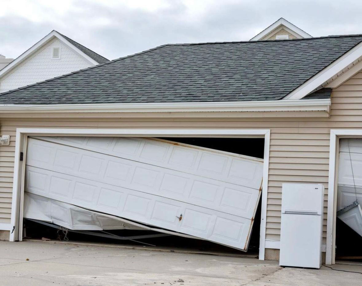 Severely damaged garage door repaired by BlackBear technician during urgent call in Long Beach